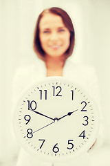 Image showing attractive businesswoman with white clock