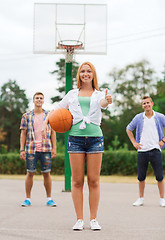 Image showing group of smiling teenagers playing basketball