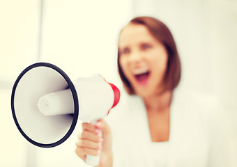 Image showing strict businesswoman shouting in megaphone