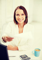 Image showing businesswoman giving papers in office