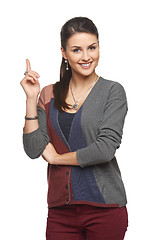 Image showing Woman in cardigan pointing at blank copy space