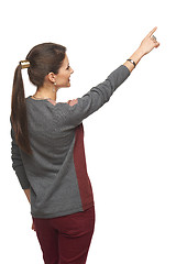 Image showing Back view of woman pointing at copy space