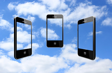 Image showing three modern mobile phones on the sky