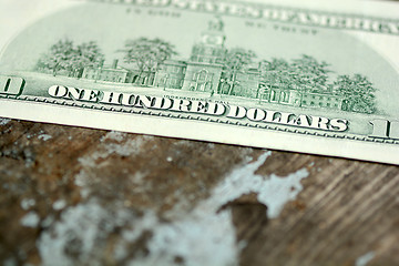 Image showing Close-up of a $100 banknotes on wooden background