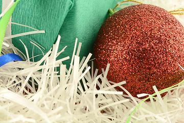 Image showing Christmas green gift with red balls on white abstract light background