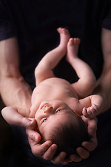 Image showing Newborn baby in dad's hands