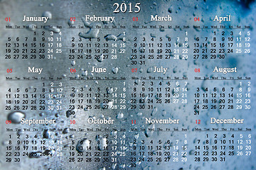 Image showing calendar for 2015 year on the surface with drops