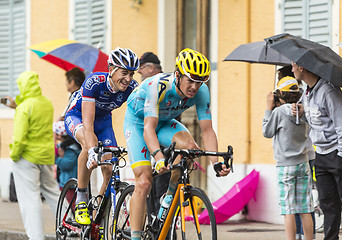 Image showing Two Cyclists Riding in the Rain