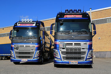 Image showing Two New Volvo FH Tanker Trucks by a Warehouse