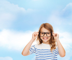 Image showing smiling cute little girl with black eyeglasses