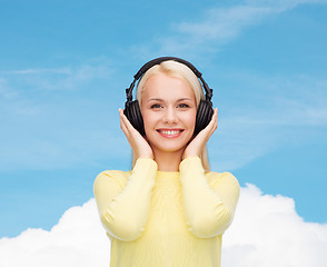 Image showing smiling young woman with headphones