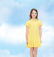 Image showing smiling little girl in yellow dress