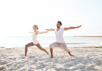 Image showing couple making yoga exercises outdoors