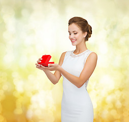 Image showing smiling woman holding red gift box