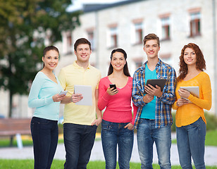 Image showing group of teenagers with smartphones and tablet pc