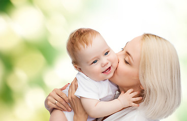 Image showing happy mother kissing smiling baby