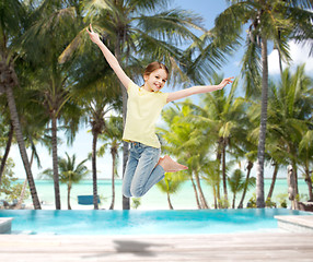 Image showing smiling little girl jumping