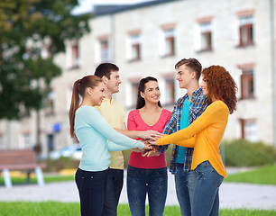 Image showing group of smiling teenagers over campus background