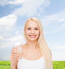 Image showing young smiling woman with glass of water