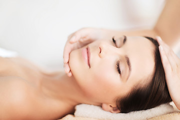 Image showing beautiful woman in spa salon having facial