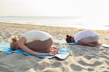 Image showing couple making yoga exercises outdoors