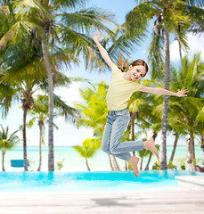 Image showing smiling little girl jumping