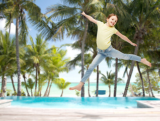 Image showing smiling little girl jumping