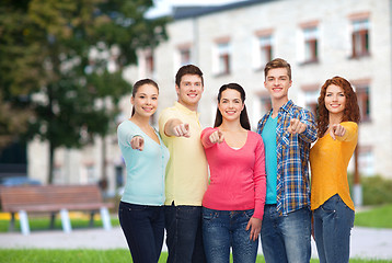 Image showing group of smiling teenagers over campus background