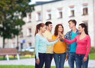 Image showing group of smiling teenagers over campus background