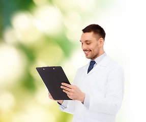 Image showing smiling male doctor with clipboard