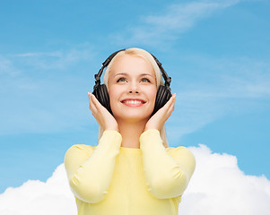 Image showing smiling young woman with headphones