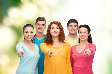 Image showing group of smiling teenagers over green background