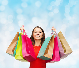 Image showing smiling woman with colorful shopping bags