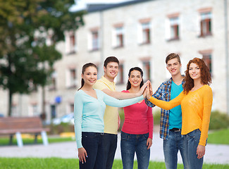Image showing group of smiling teenagers over campus background
