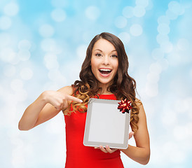 Image showing smiling woman in red dress with tablet pc