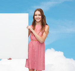 Image showing young woman in dress with white blank board