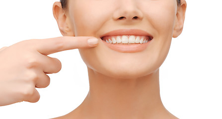 Image showing beautiful woman pointing to teeth