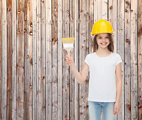 Image showing smiling little girl in helmet with paint brush