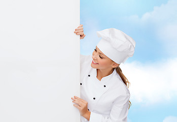 Image showing smiling female chef with white blank board