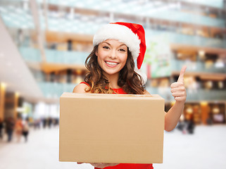 Image showing smiling woman in santa helper hat with parcel box