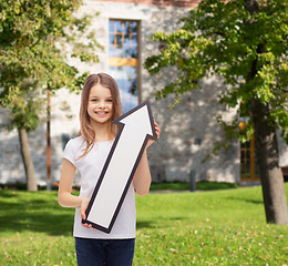 Image showing smiling little girl with blank arrow pointing up