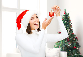 Image showing woman in santa helper hat with christmas ball