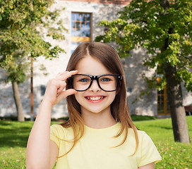 Image showing smiling cute little girl in black eyeglasses