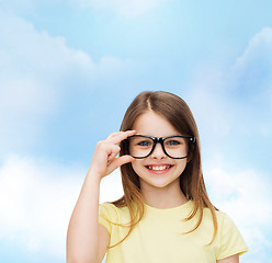 Image showing smiling cute little girl in black eyeglasses