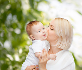 Image showing happy mother kissing smiling baby