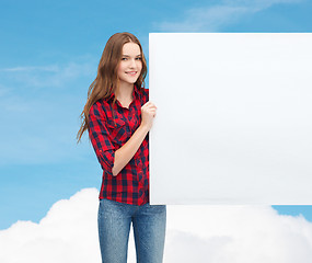 Image showing smiling young teenage girl with white blank board