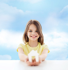 Image showing beautiful little girl holding paper house cutout