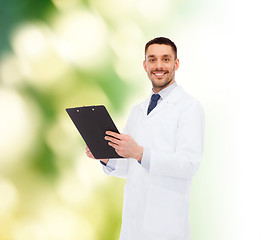 Image showing smiling male doctor with clipboard