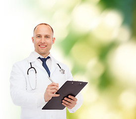 Image showing smiling male doctor with clipboard and stethoscope