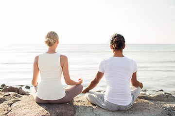 Image showing couple making yoga exercises outdoors